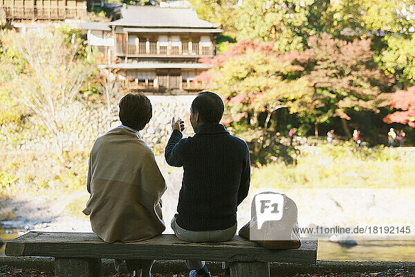 Japanese senior couple traveling in the autumn leaves season