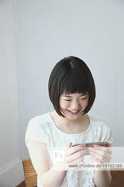 Young Japanese woman looking at mobile phone