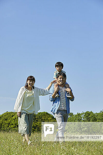 Japanese family walking in the field