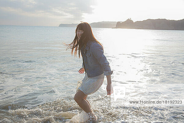 Young Japanese woman frolic on the beach