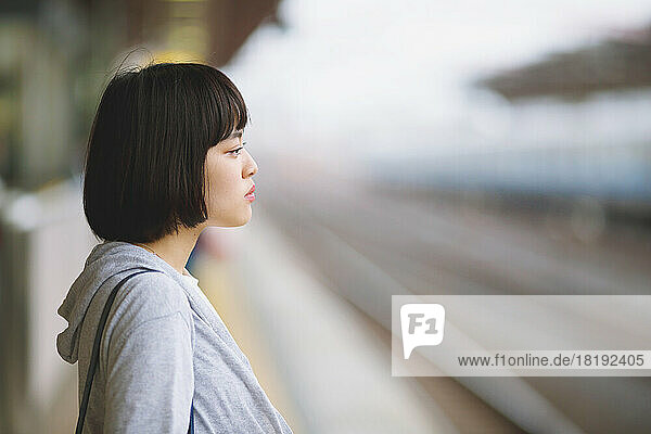 Young Japanese woman on the train platform