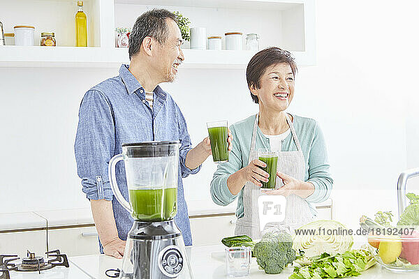 Japanese senior couple drinking green juice