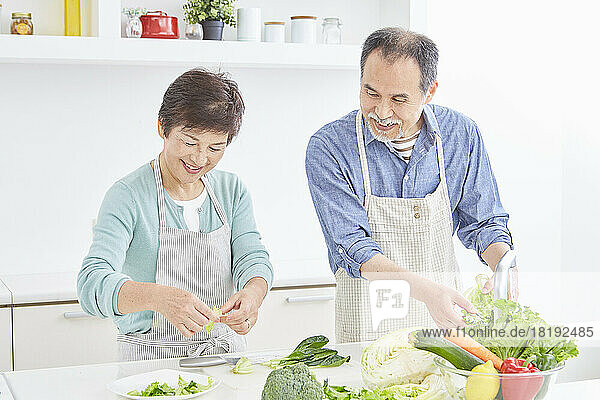 Japanese senior couple preparing a meal