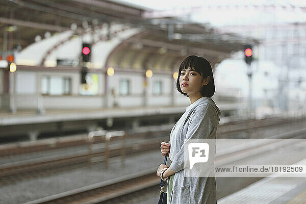 Young Japanese woman on a train platform