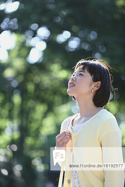Young Japanese woman walking in the park