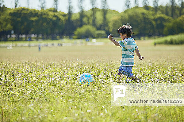 Japanese boy playing with a ball