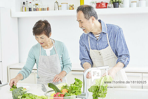 Japanese senior couple preparing a meal