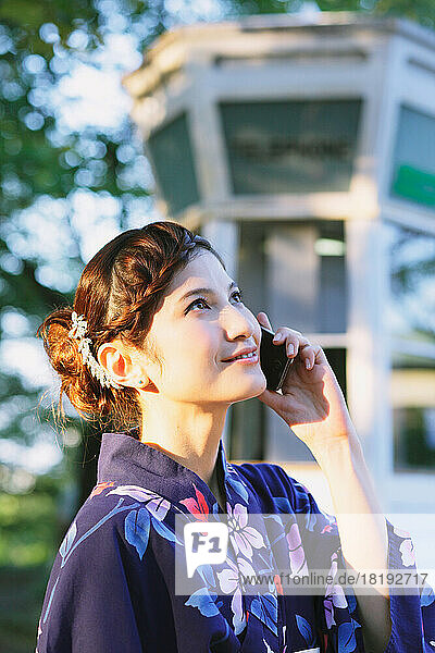 Japanese woman in a yukata making a phone call