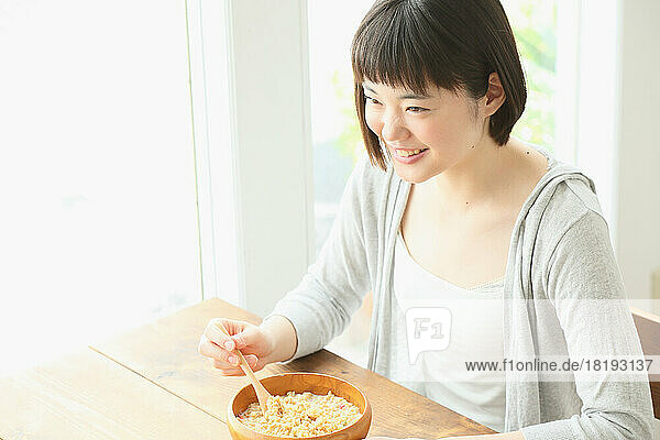 Young Japanese woman having breakfast