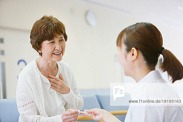 Japanese senior woman measuring fever