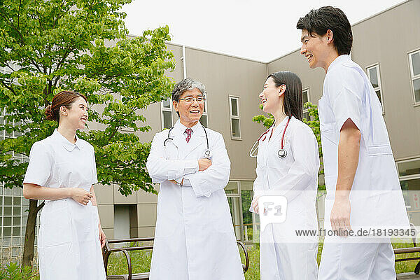 Nurses and doctors talking outdoors