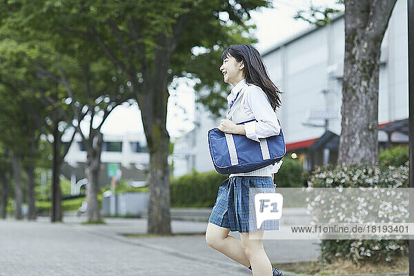 Japanese high school girl running with a smile