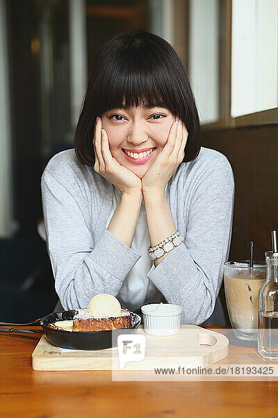 Young Japanese woman enjoying her french toast