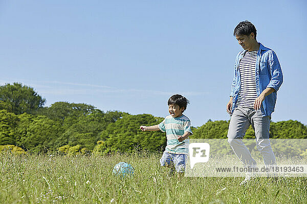 Japanese parent and child playing with a ball