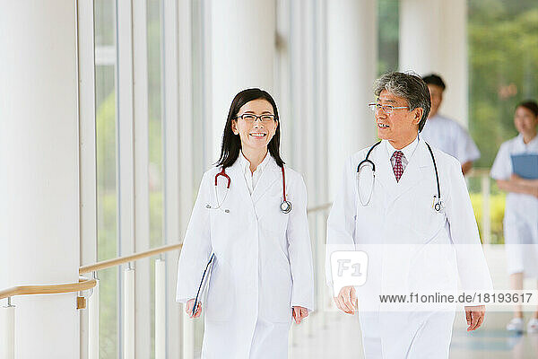 Smiling doctors walking in the hallway