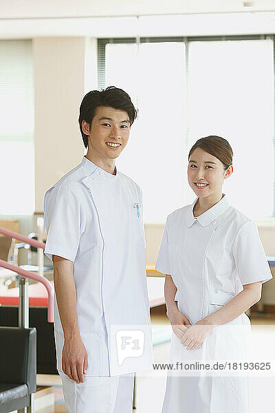 Smiling young Japanese nurses in rehab facility