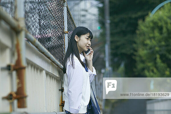 Japanese high school girl making a phone call