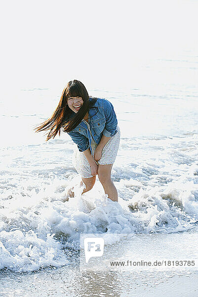 Young Japanese woman having fun on the beach