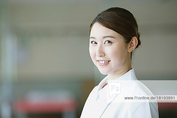 Smiling young Japanese female nurse
