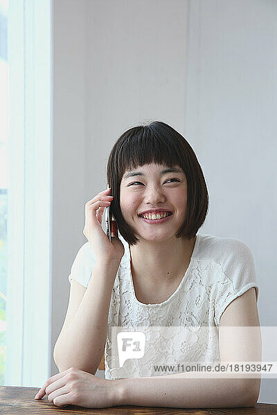 Young Japanese woman calling on a mobile phone