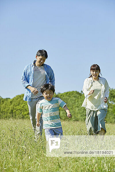 Japanese family running in the field