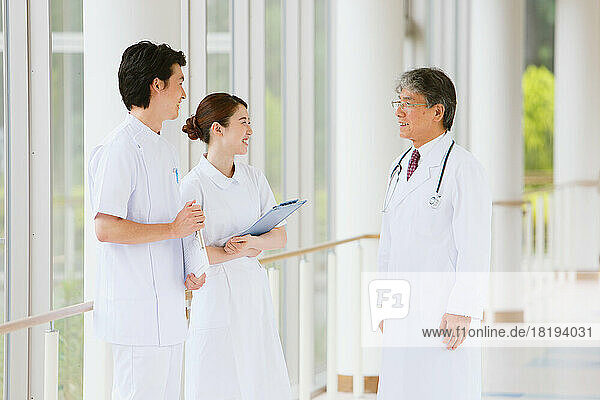 Japanese nurses and doctor talking in the hallway
