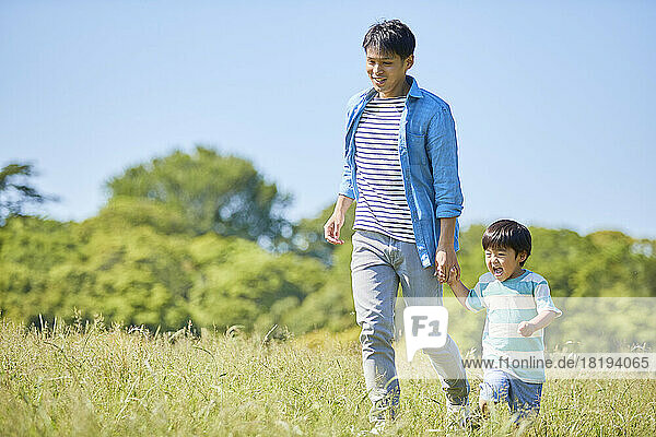 Japanese parent and child holding hands while walking