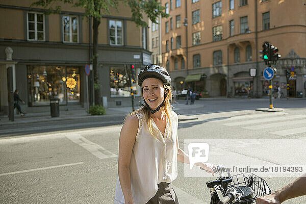 Young woman with bicycle on city street