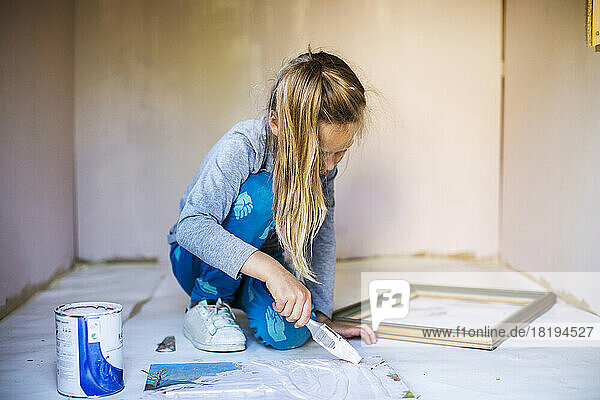 Girl painting during home renovation