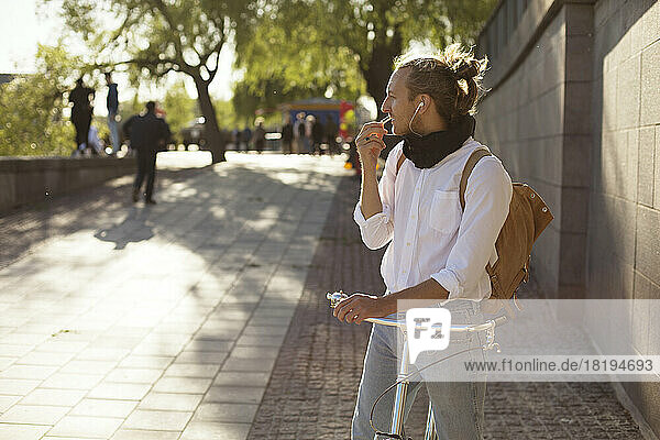 Man with bicycle talking on phone