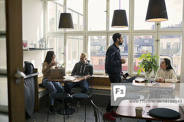 Coworkers talking in office break room
