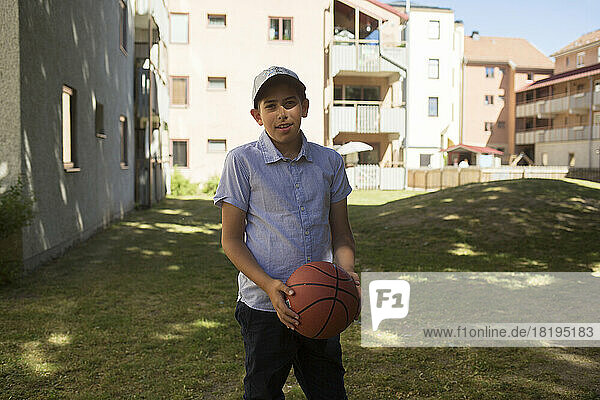 Portrait of boy holding basketball
