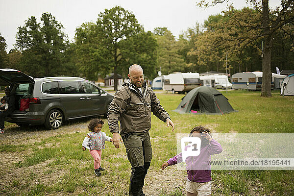 Man with his daughters while camping
