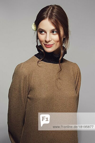 Portrait of a young cute woman in warm wool sweater. Clean pretty face with natural makeup