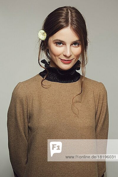 Portrait of a young shy girl in warm wool sweater. Clean pretty face with natural makeup