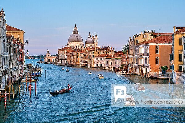 VENICE  ITLAY  JULY 19  2019: View of Venice Grand Canal with boats and Santa Maria della Salute church on sunset from Ponte dell'Accademia bridge. Venice  Italy  Europe