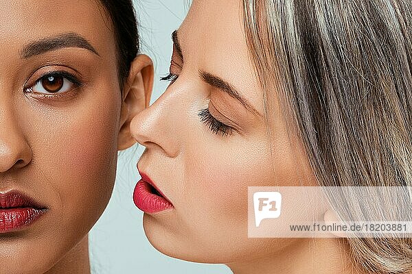 Close up portrait of beautiful african and caucasian young women with different types of skin