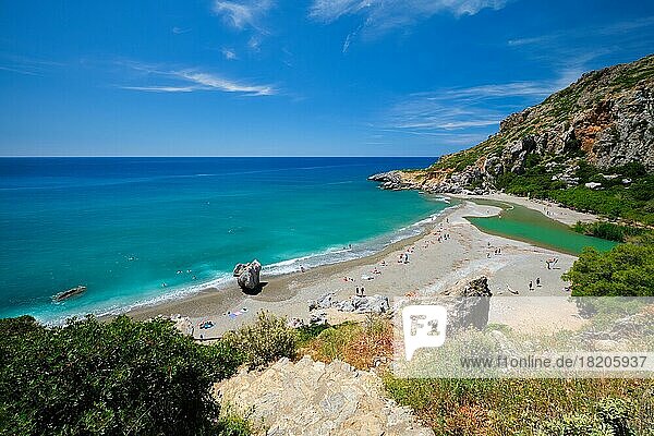 View of Preveli beach on Crete island with relaxing people and Mediterranean sea. Crete island  Greece  Europe