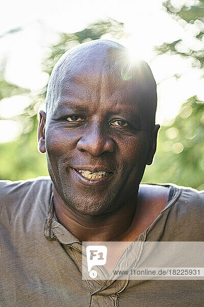 Cheerful senior African American man looking at the camera while standing outdoors