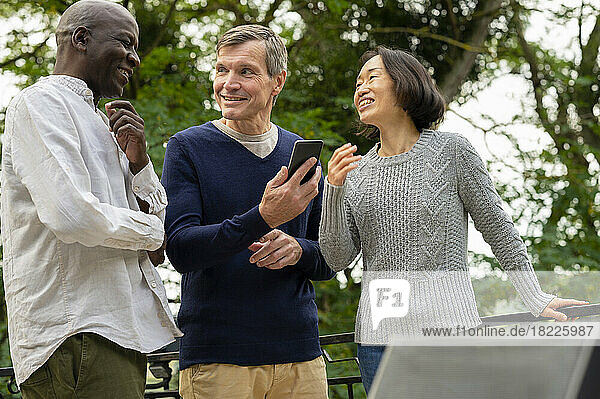 Portrait of three diverse friends enjoying each other's company inpublic park