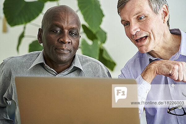 Two male business partners working together from home