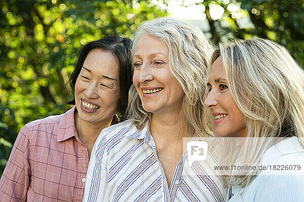 Group of diverse life-long lady friends posing for photo outdoors