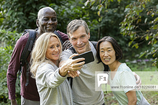 Diverse group of middle-aged friends taking a selfie while out on the backroad trails