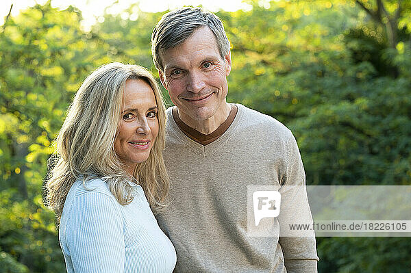 Portrait of middle-aged heterosexual couple posing outdoors