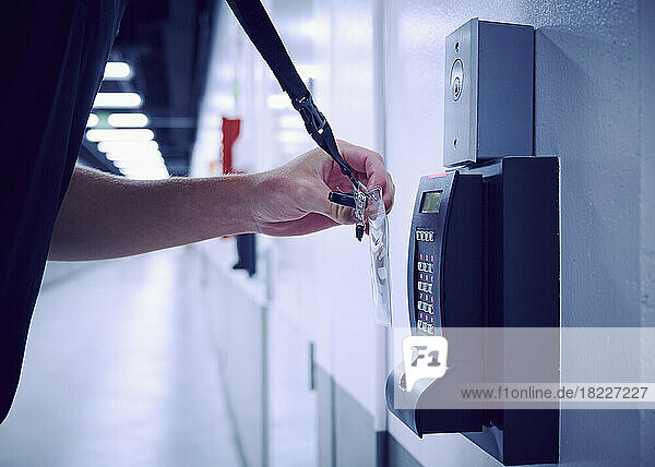Close-up of employee using keycard and digital door lock in office