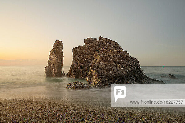 Monterosso beach rocks in long expo at sunrise