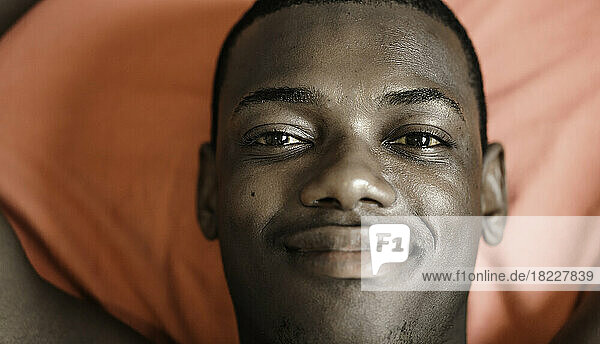 Happy black man on red blanket