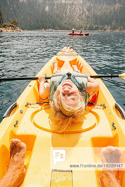 Smiling boy (8-9) in kayak