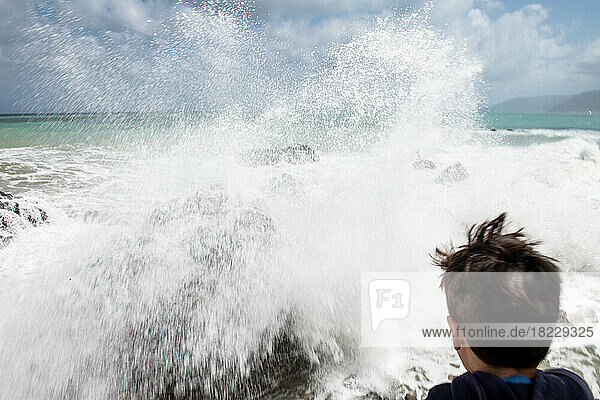 Italy  Sicily  Boy (10-11) looking at?sea waves crashing