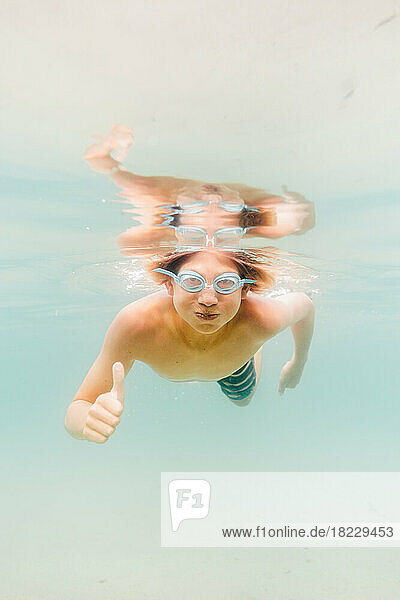 Boy (12-13) swimming underwater